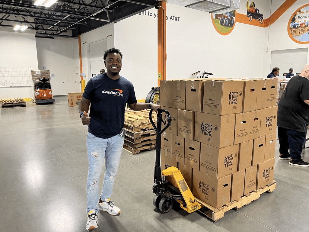 Volunteer from Captial One with Pallet full of Boxes
