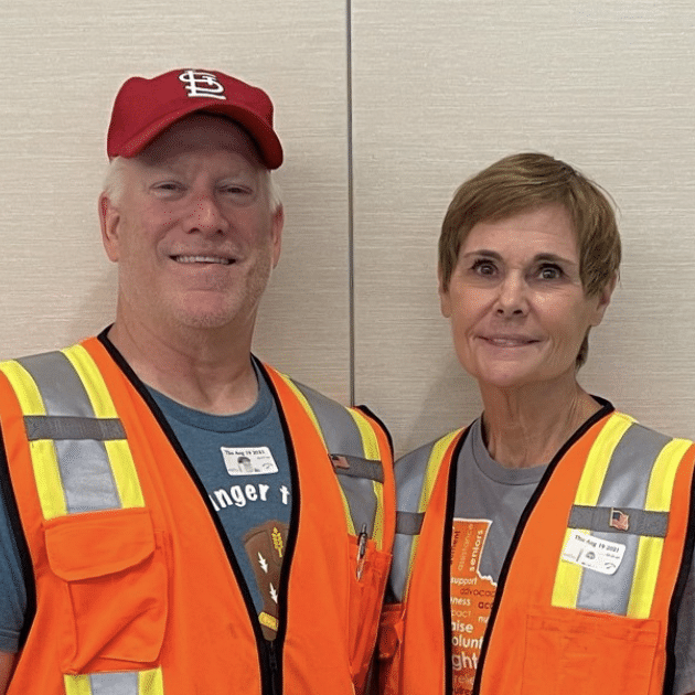 Max and Jill Older white couple wearing orange safety vests