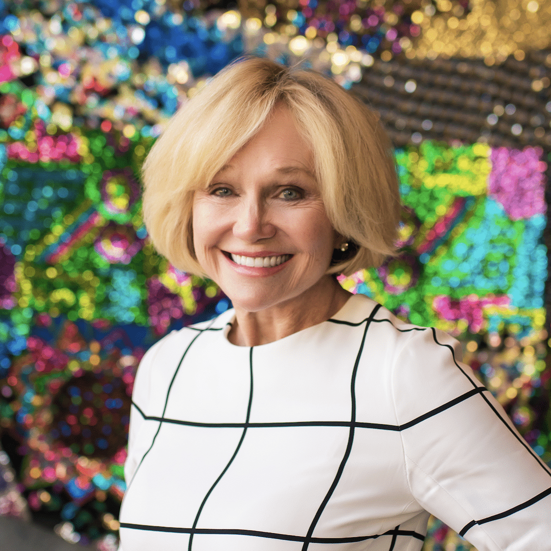 Kathryn Hall Kathryn Hall standing in front of a multicolor sparkly background
